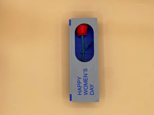Closed blue-and-gray Women's Day gift box with a red rose visible through the window
