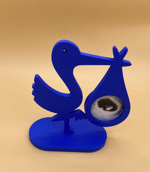 Blue stork ultrasound photo holder displaying an ultrasound photo